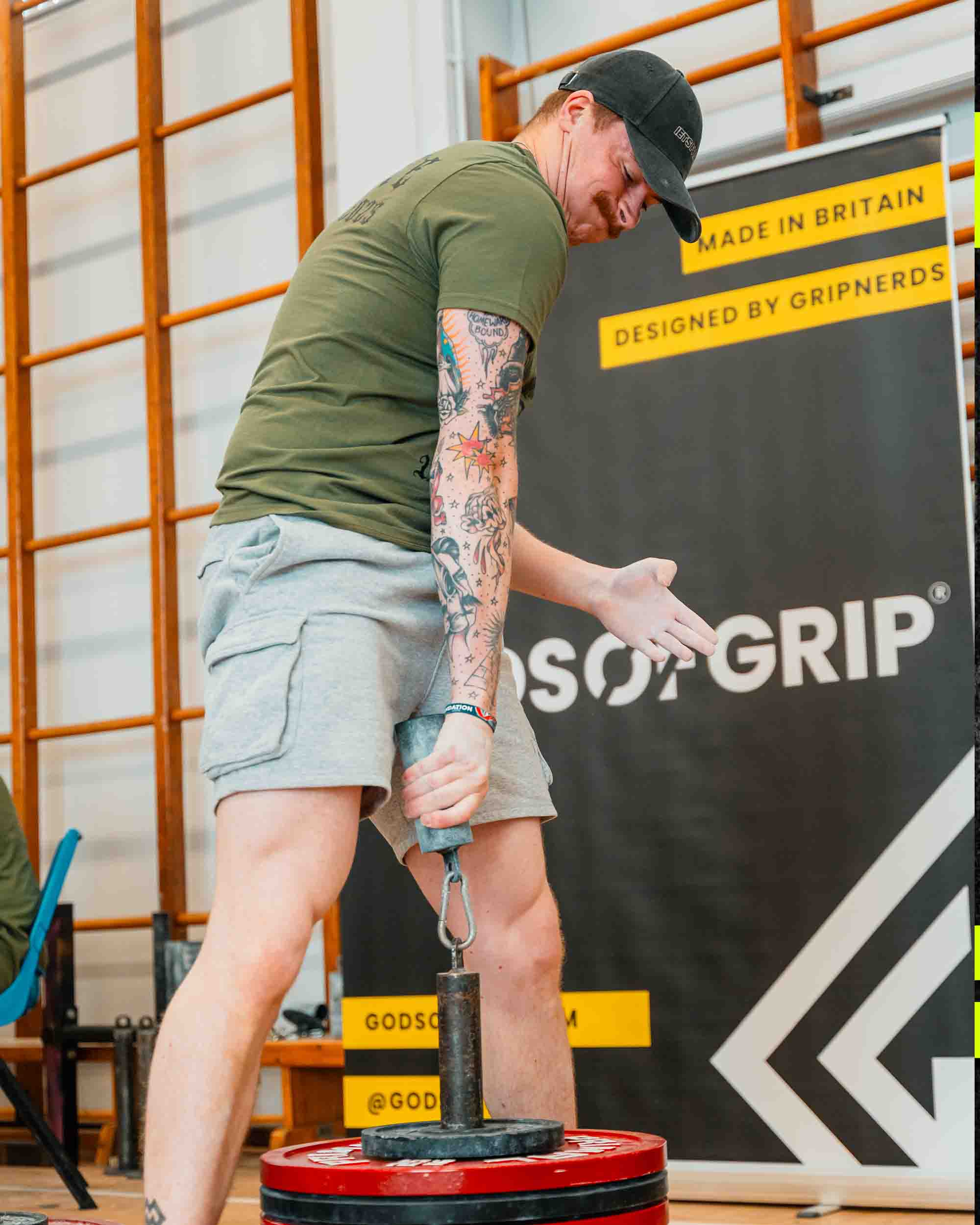 Person using a weightlifting device with 'Gripns' branding in the background